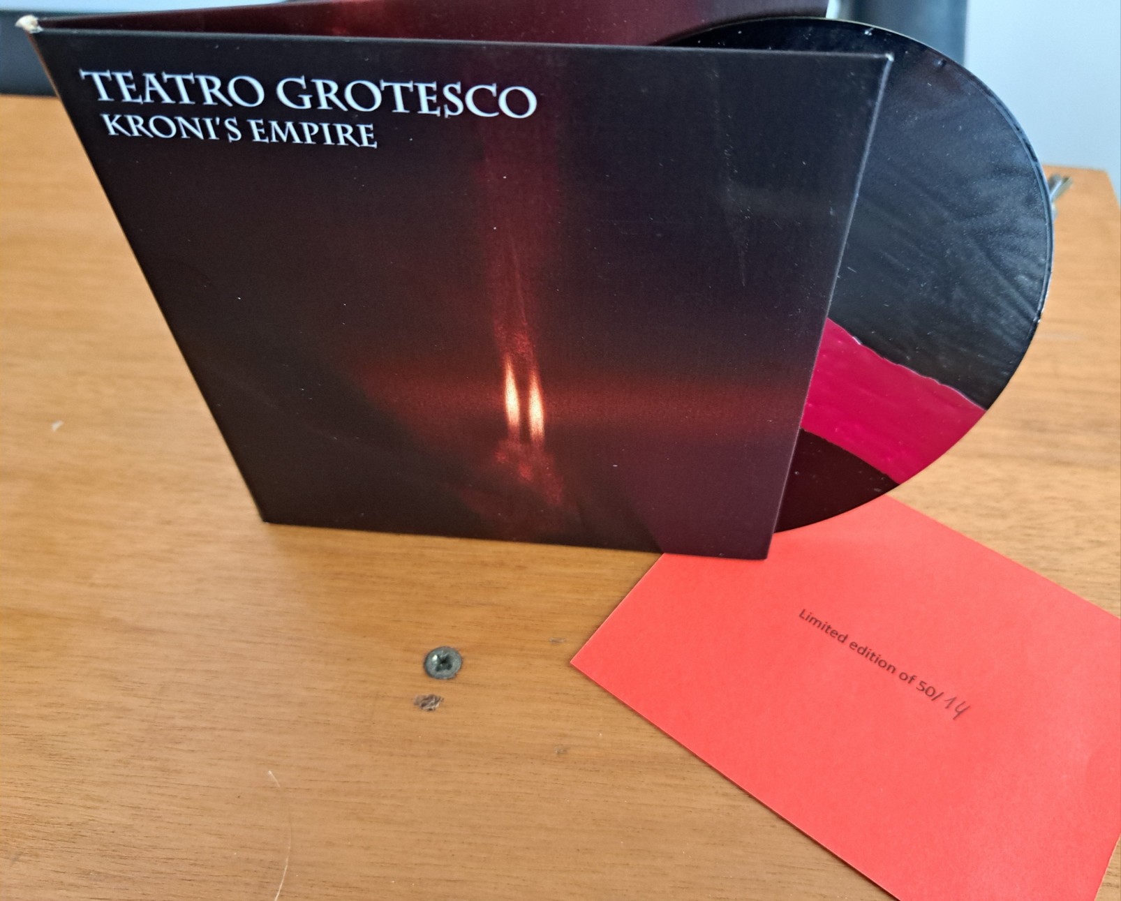 A picture of Kroni's Empire, Teatro Grotesco's full album on CD. The disc itself was hand-painted in this 50 copies limited edition, and this copy is numbered 14.
