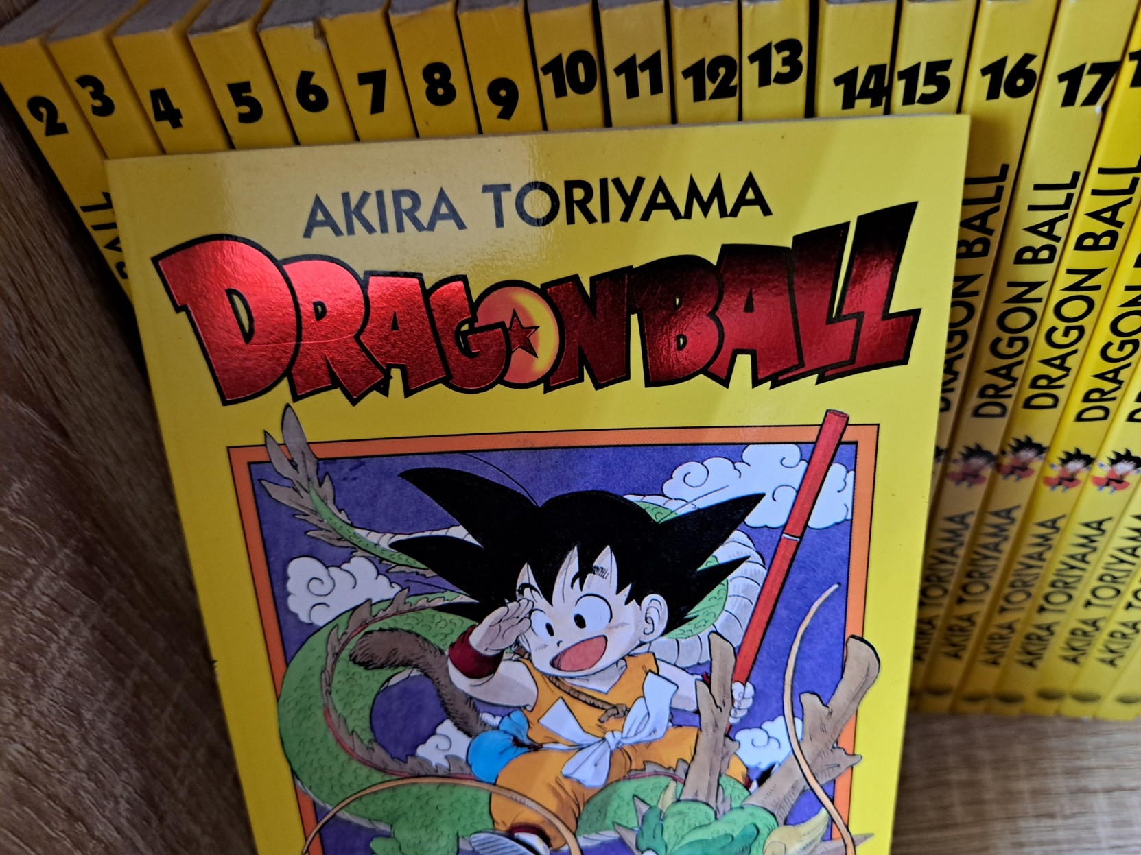 A picture of Akira Toriyama's most famous work, Dragon Ball. The first book cover is shown, in front of the spines to the rest of it (numbers 2 to 23 visible).