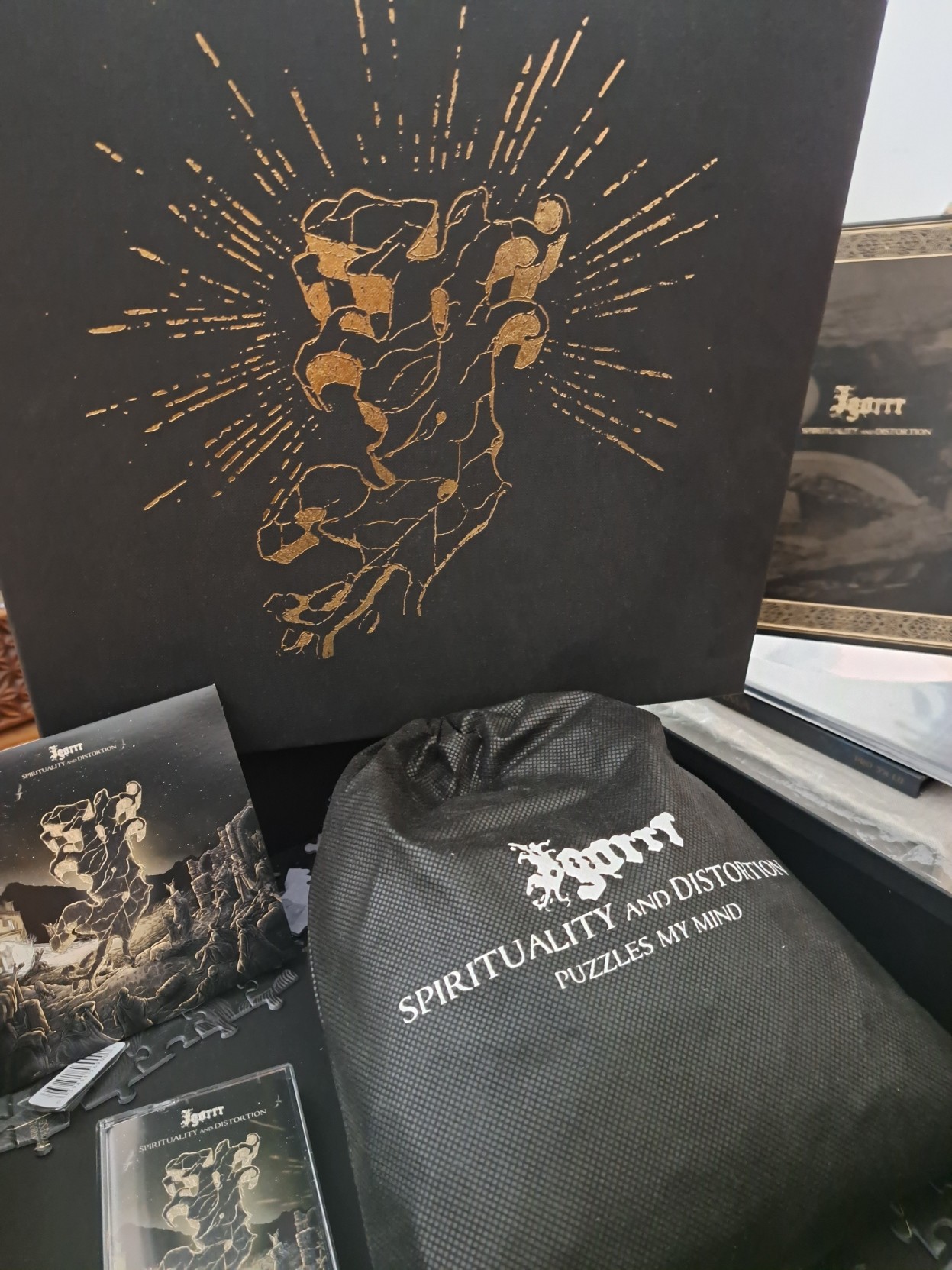 It's a box, a book, a bag, a puzzle A cassette, a CD, a necklace, a double LP  It's Igorrr's Spirituality And Distortion!